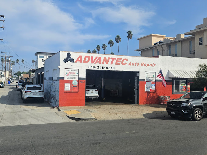 Advantec Auto Repair shop on Adams Avenue, San Diego, with an open garage, parked cars, and palm trees in the background.