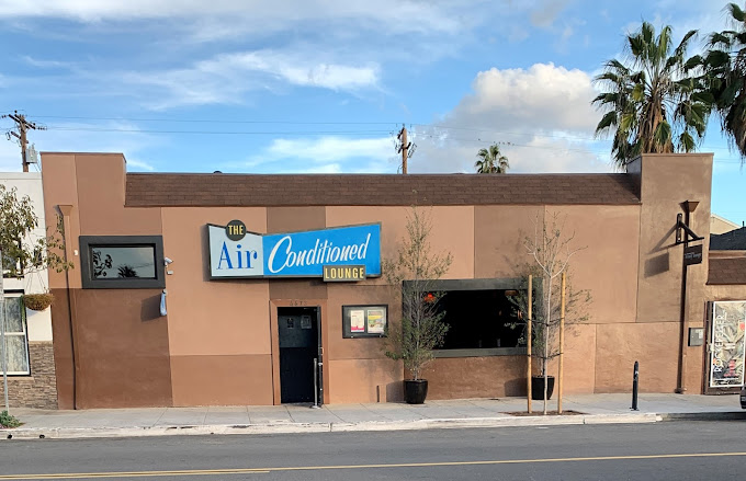 Air Conditioned Lounge interior with vibrant lights and dance floor on 30th St, San Diego.