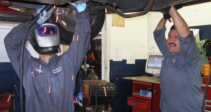 Auto mechanics at Smitty’s Service performing vehicle repairs in Adams Avenue, San Diego.
