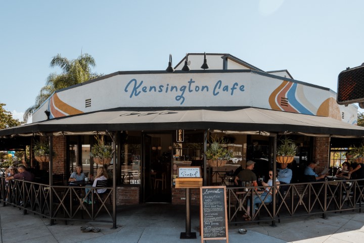 Exterior view of Kensington Cafe with outdoor seating on Adams Ave, San Diego.