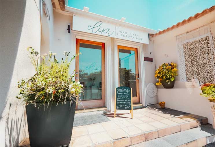 Elixr Wax Bar storefront on Adams Ave, San Diego, with a white exterior and welcoming sign.