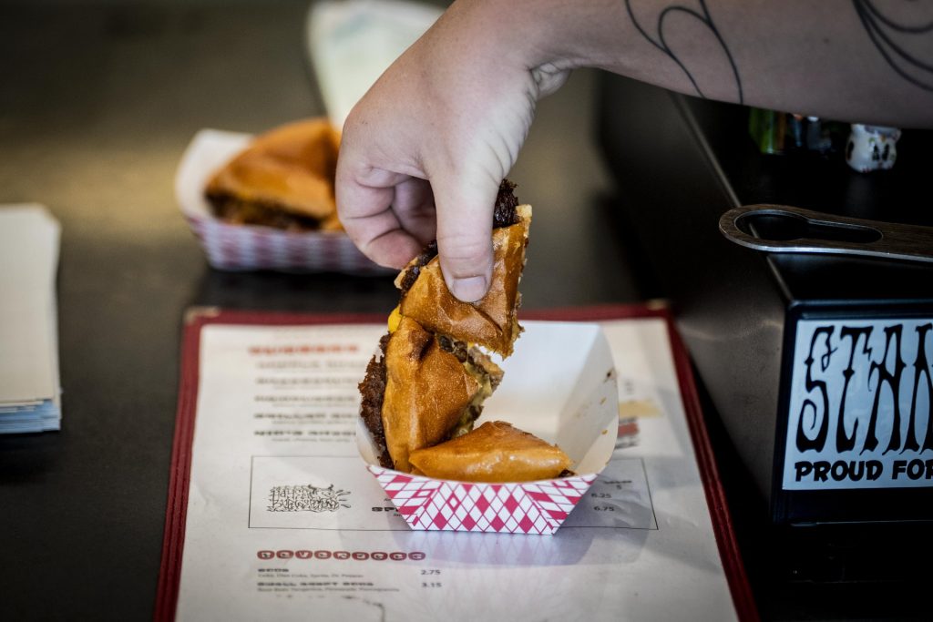 Hayes Burger serves burgers to participants in the 2025 Taste of Adams Avenue  on Sunday, June 29, 2025 in San Diego, California. (Sam Hodgson / Uptown 11 Studios)