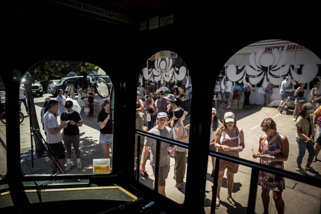 People board the Old Town Trolley as restaurants serve up special tasting items to participants in the 2025 Taste of Adams Avenue  on Sunday, June 29, 2025 in San Diego, California. (Sam Hodgson / Uptown 11 Studios)