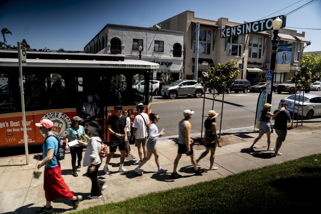 People climb off the Old Town Trolley as restaurants serve up special tasting items to participants in the 2025 Taste of Adams Avenue  on Sunday, June 29, 2025 in San Diego, California. (Sam Hodgson / Uptown 11 Studios)