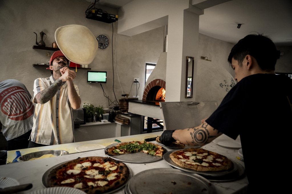 Bosforo serves up slices of pizza to participants in the 2025 Taste of Adams Avenue on Sunday, June 29, 2025 in San Diego, California. (Sam Hodgson / Uptown 11 Studios)
